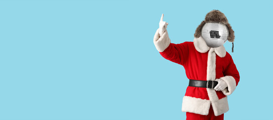 Santa Claus with disco ball instead of his head on light blue background with space for text