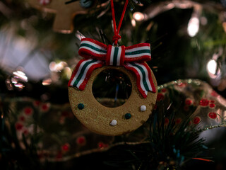 Close up of cookie christmas decoration with red and white ribbon
