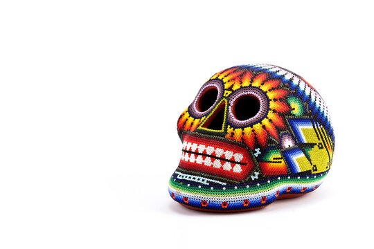 Colorful skulls, Mexican handicrafts. Day of the Dead, handmade Huichol figure of chaquira, Mexico	