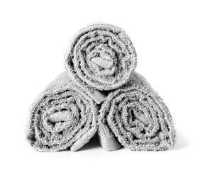 Stack of rolled towels on white background