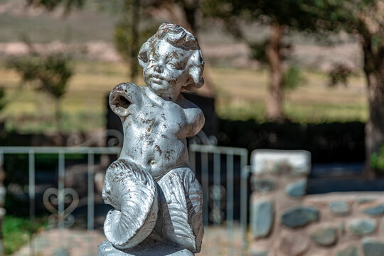 La Poma, Argentina - April 11, 2022: damaged statue of a child in the square