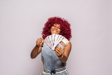 happy african lady flaunting some cash