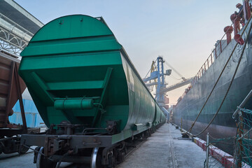 Port grain elevator. Industrial sea trading port bulk cargo zone Railway wagon in grain terminal