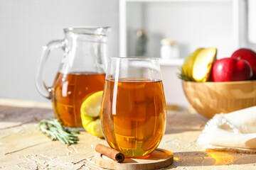 Glass of tasty apple juice on table