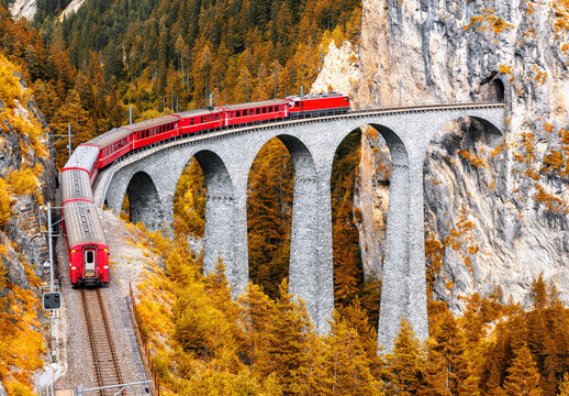 Bernina express glacier train on Landwasser Viaduct in autumn, Switzerland