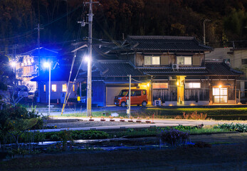 Fototapeta na wymiar Traditional wooden Japanese house on quiet street country at night