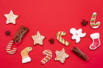 Composition with tasty Christmas cookies and spices on red background