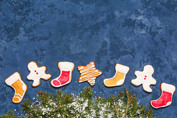 Composition with sweet Christmas cookies and fir branches on color background