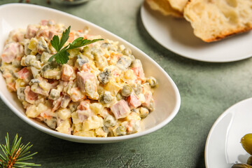 Bowl of Olivier salad on grunge background, closeup