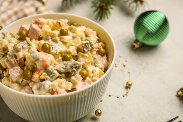 Bowl of Olivier salad on white background, closeup