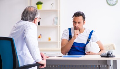 Young male contractor visiting old doctor