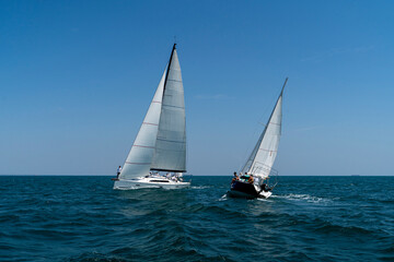Sailing. Yacht ship with white sails in open sea. Luxury boats.. Yachting. Luxury Yachts.