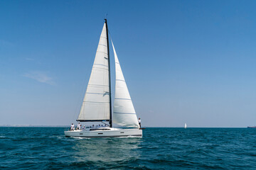 Sailing. Yacht ship with white sails in open sea. Luxury boats.. Yachting. Luxury Yachts.