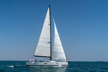 Sailing. Yacht ship with white sails in open sea. Luxury boats.. Yachting. Luxury Yachts.