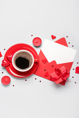 Blank letter with gift, candles and cup of coffee on grey background. Valentine's Day celebration