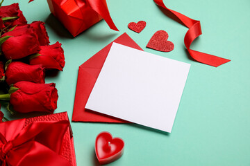 Blank letter with roses and gifts on green background. Valentine's Day celebration