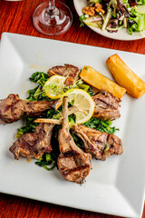 Pork chops. Pork chops seasoned with cracked black pepper and grilled. Pork served with classic steakhouse side dishes: asparagus and mashed potatoes. Classic fine dining entree.