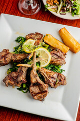 Pork chops. Pork chops seasoned with cracked black pepper and grilled. Pork served with classic steakhouse side dishes: asparagus and mashed potatoes. Classic fine dining entree.