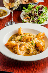 Shrimp and Grits. Grits and old bay seasoned jumbo shrimp topped with spices and micro greens. Classic American Diner Style Breakfast or Brunch menu item. Traditional low country southern staple. 