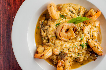 Shrimp and Grits. Grits and old bay seasoned jumbo shrimp topped with spices and micro greens. Classic American Diner Style Breakfast or Brunch menu item. Traditional low country southern staple. 