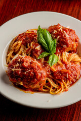 Spaghetti and meatballs. Pasta with homemade meatballs, Parmesan cheese and Italian parsley. Classic American or Italian restaurant favorite. Homemade pasta with tomato sauce, meats and cheeses.