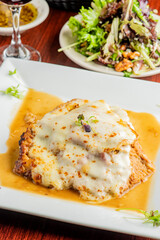 Veal parmigiana. Traditional Italian comfort dish. Chicken breast covered in breadcrumbs fried, topped with marinara sauce, melted mozzarella, parmigiana and provolone cheeses and Italian parsley