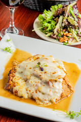 Veal parmigiana. Traditional Italian comfort dish. Chicken breast covered in breadcrumbs fried, topped with marinara sauce, melted mozzarella, parmigiana and provolone cheeses and Italian parsley