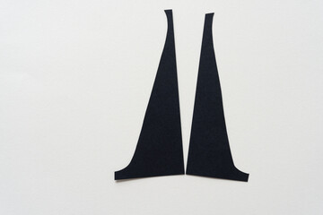 two black paper shapes (triangles) or upside down stocking legs of the countess dancer - obrazy, fototapety, plakaty