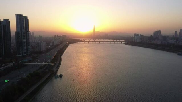 Aerial view, drone view,Scenery of Seoul, South Korea, at dawn and golden sunlight reflects on the Han River.Seoul traffic at dawn