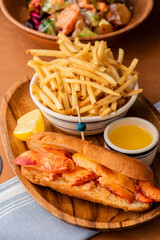 Lobster Roll. Traditional classic American Sandwich. New England classic, fresh Maine Lobster boiled, mixed with mayo, celery, chives served in toasted hero roll with crisp lettuce and drawn butter.