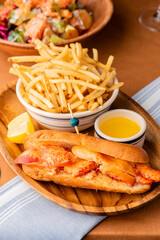 Lobster Roll. Traditional classic American Sandwich. New England classic, fresh Maine Lobster boiled, mixed with mayo, celery, chives served in toasted hero roll with crisp lettuce and drawn butter.