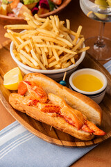 Lobster Roll. Traditional classic American Sandwich. New England classic, fresh Maine Lobster boiled, mixed with mayo, celery, chives served in toasted hero roll with crisp lettuce and drawn butter.