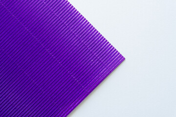 purple foil corrugated paper corner on blank paper