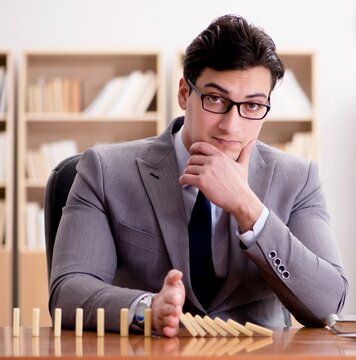 Businessman With Dominoes In The Office