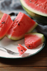 Sliced fresh juicy watermelon on wooden table, closeup