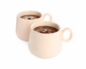 Cups of delicious hot chocolate on white background
