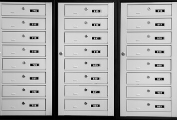 Fototapeta premium Closed metal mailboxes with keyholes and sequence numbers indoors