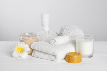 Spa composition with care products on white wooden table
