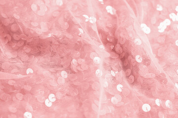 Beautiful pink fabric with shiny sequins as background, closeup