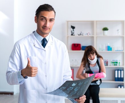 Young woman visiting male doctor traumatologist
