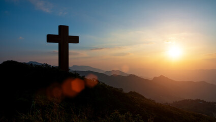 Silhouettes of Christian cross symbol on top mountain at sunrise sky background. Concept of...