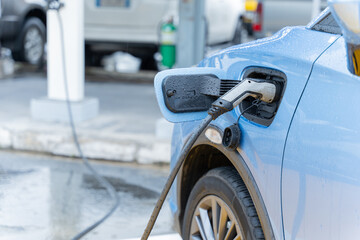 Fototapeta na wymiar Electric car on electric car charging station. Power supply for electric car charging. Clean energy concept