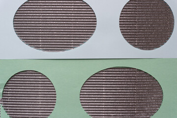 paper stencil with oval shape cutouts on corrugated paper