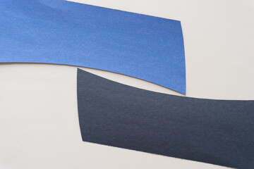 blue and black construction paper shapes on a plain background