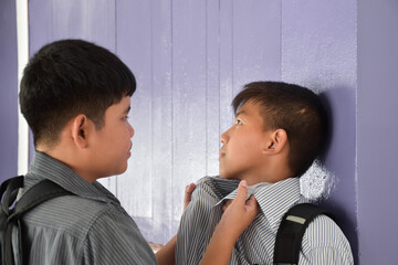 Soft focus of Southeast Asian boys are quarreling and fighting, fights between friends, misunderstandings and mutual forgiveness among friends concept.