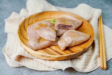 susubukkumi, Korean Pan-fried Millet Rice Cake : or this dish, first make the dough by mixing glutinous sorghum powder with warm water. Next, fry flattened dough balls on a pan, add red bean filling, 