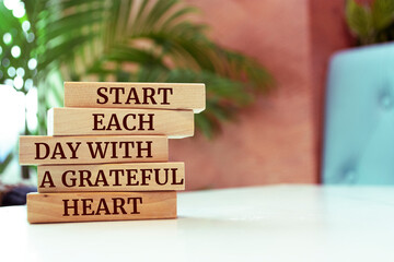 Wooden blocks with words 'Start Each Day With a Grateful Heart'.