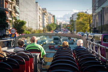 View from open roof of red, turistic hop on bus with tourists inside. Vacation, travel concept