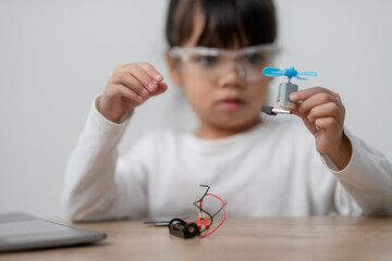 Asia students learn at home in coding robot cars and electronic board cables in STEM, STEAM, mathematics engineering science technology computer code in robotics for kids concept.