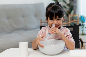 Little asian girl saline nasal wash nose at home. - obrazy, fototapety, plakaty